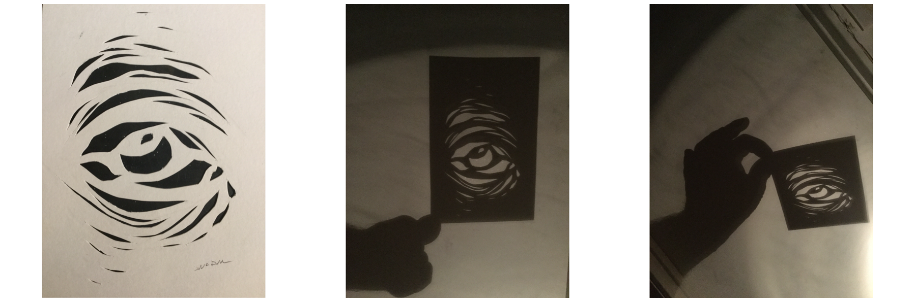 Three images. The first of an eye created by cutting out shapes in paper. The next two of a shadow of a hand holding hat paper with light behind it.
