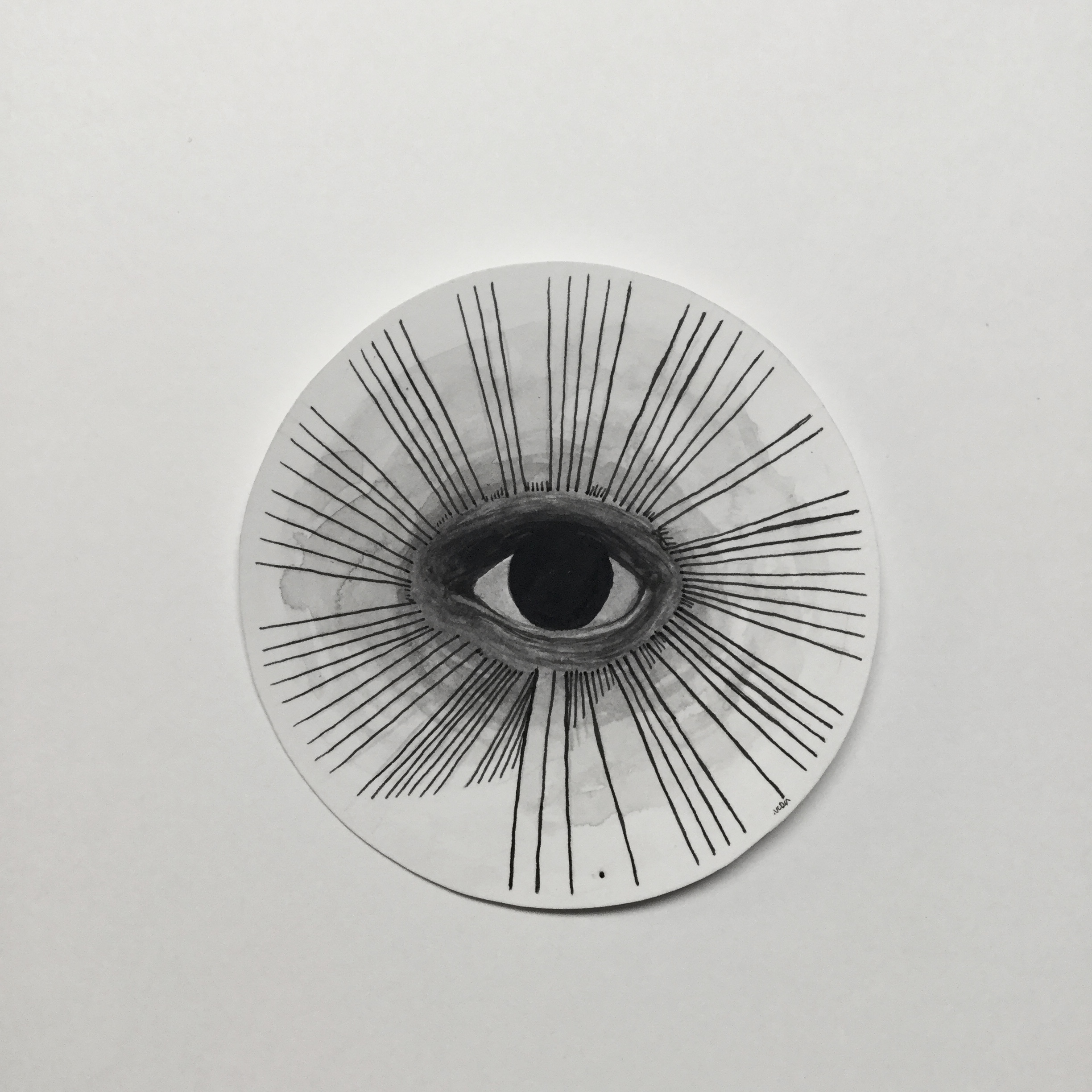Ink illustration of an eye with a completely black pupil and iris. Surrounding the eye are lines representing the beginning of pi. The illustration is on a circle.